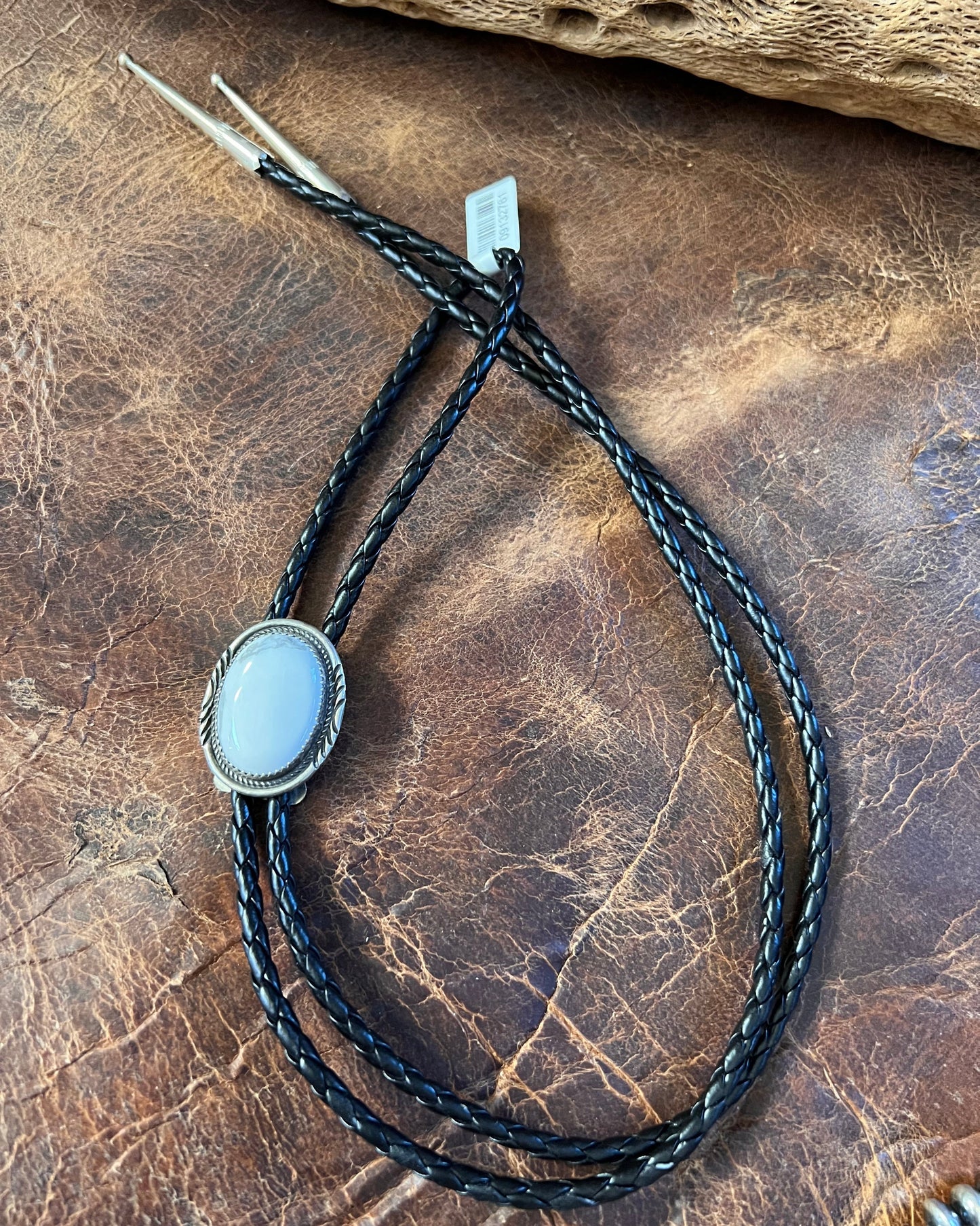 Handmade by Bobby Begay. White Buffalo and Sterling with Black Braided Leather Bolo Necklace with Sterling Tips