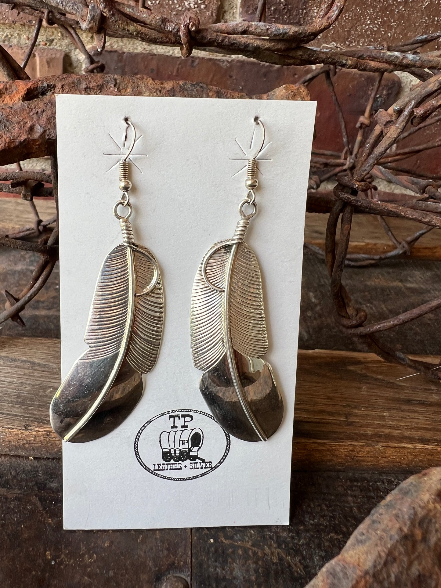 Navajo Handmade by Chester Charley Sterling silver high-shine feather dangle earrings
3” long