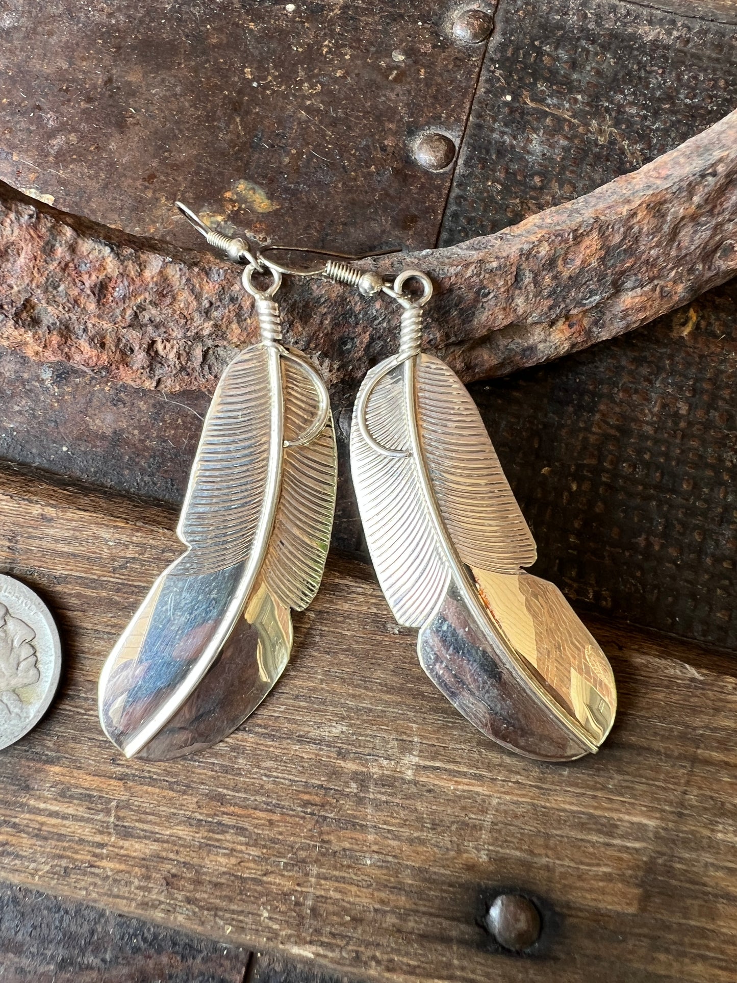 Navajo Handmade by Chester Charley Sterling silver high-shine feather dangle earrings
3” long