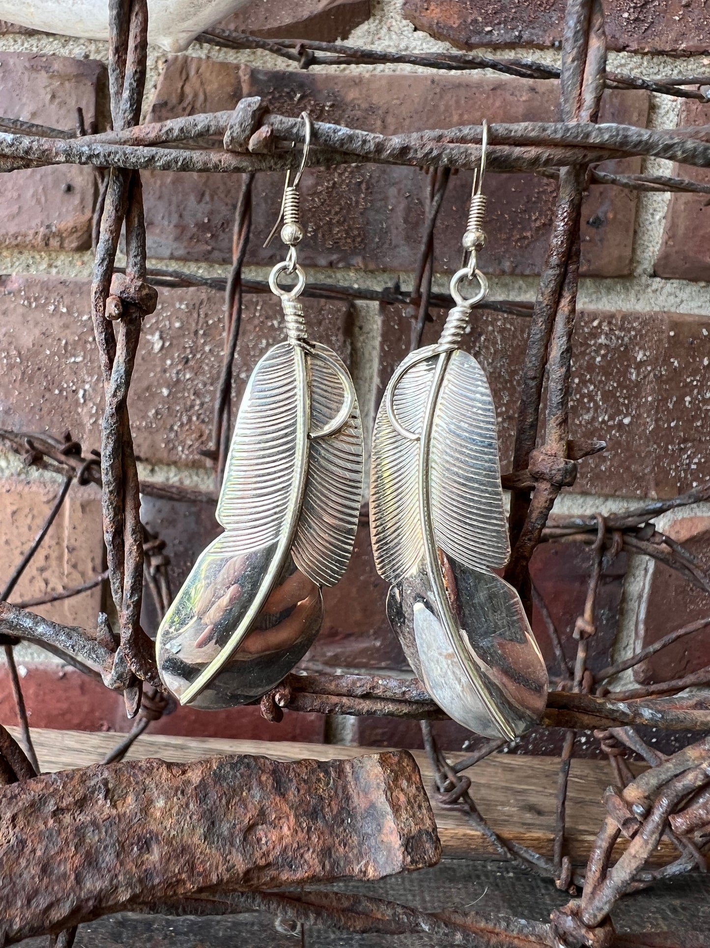 Navajo Handmade by Chester Charley Sterling silver high-shine feather dangle earrings
3” long